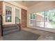 Relaxing sunroom with brick accent wall, neutral carpeting, and large picture windows overlooking the backyard at 2222 Hearthstone Dr, Gastonia, NC 28056
