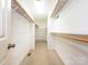 Organized walk-in closet with shelving and hanging rods for efficient storage solutions at 2222 Hearthstone Dr, Gastonia, NC 28056