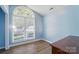 Bright bedroom features wood floors, light blue walls, and a large window at 2432 Barkers Ridge Dr, Bessemer City, NC 28016