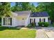 Charming one-story home with white siding, black shutters, and a well-manicured lawn and garden at 2432 Barkers Ridge Dr, Bessemer City, NC 28016