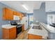 Well-lit kitchen features wooden cabinets and stainless steel appliances at 2432 Barkers Ridge Dr, Bessemer City, NC 28016