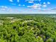 Captured from above, a lush neighborhood with houses nestled among towering trees at 245 Kingsway Cir, Charlotte, NC 28214