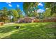 Expansive backyard with lush green grass and a charming brick home at 245 Kingsway Cir, Charlotte, NC 28214