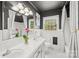 Bathroom featuring double vanity, tub and shower with monochrome walls at 245 Kingsway Cir, Charlotte, NC 28214