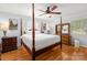 Bedroom with four-poster bed, wood floors, neutral walls, and ceiling fan at 245 Kingsway Cir, Charlotte, NC 28214
