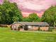 Charming brick ranch home features a lush lawn, mature trees, and a welcoming front entrance at 245 Kingsway Cir, Charlotte, NC 28214
