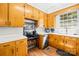 Cozy kitchen with light wood cabinets, white countertops, and modern stainless steel appliances at 245 Kingsway Cir, Charlotte, NC 28214