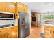 Open kitchen leading to dining area with stainless steel appliances and ample cabinetry at 245 Kingsway Cir, Charlotte, NC 28214