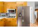 Kitchen area with light wood cabinets and stainless steel refrigerator at 245 Kingsway Cir, Charlotte, NC 28214