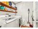 Bright laundry room with open shelving and white washer and dryer units at 245 Kingsway Cir, Charlotte, NC 28214
