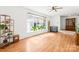 Bright living room with a large window and plants, hardwood floors, and classic decor at 245 Kingsway Cir, Charlotte, NC 28214