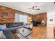 Comfortable living room with a brick accent wall, fireplace, and cozy sectional sofa at 245 Kingsway Cir, Charlotte, NC 28214