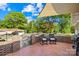 Inviting outdoor brick patio with seating and partial shade from a canopy at 245 Kingsway Cir, Charlotte, NC 28214