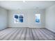 Spacious bonus room with neutral carpet, painted walls, and two windows offering lots of natural light at 2535 Ruby Dixon Crossing Dr # 19, Gastonia, NC 28056