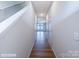 Hallway features hardwood floors, neutral walls, and a view towards the window and an open doorway at the end at 2535 Ruby Dixon Crossing Dr # 19, Gastonia, NC 28056