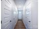 Hallway featuring wood floors, white doors, and neutral walls, creating a bright and inviting space at 2535 Ruby Dixon Crossing Dr # 19, Gastonia, NC 28056