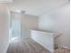 Hallway with neutral carpet, painted walls, and natural light coming in through an open doorway at 2535 Ruby Dixon Crossing Dr # 19, Gastonia, NC 28056