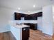 Modern kitchen features dark cabinetry, a white countertop island, and stainless steel appliances at 2535 Ruby Dixon Crossing Dr # 19, Gastonia, NC 28056