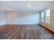 Bright, open-concept living room with wood flooring and large windows allowing for lots of natural light at 2535 Ruby Dixon Crossing Dr # 19, Gastonia, NC 28056