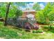 Backyard featuring a multi-level wooden deck, brick exterior, and mature landscaping at 2730 Tiffany Dr, Rock Hill, SC 29732