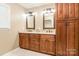 Bathroom featuring dual sinks, granite counters, wood cabinetry, and a storage cabinet at 2730 Tiffany Dr, Rock Hill, SC 29732