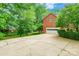 Brick home with spacious driveway and a two-car garage surrounded by lush green trees at 2730 Tiffany Dr, Rock Hill, SC 29732