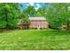 Charming two-story brick home with a manicured lawn and mature trees offering curb appeal at 2730 Tiffany Dr, Rock Hill, SC 29732