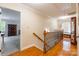 Upstairs hallway featuring hardwood floors, decorative railing, and neutral paint at 2730 Tiffany Dr, Rock Hill, SC 29732
