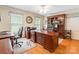Inviting home office with custom built-ins, hardwood floors, and a large executive desk at 2730 Tiffany Dr, Rock Hill, SC 29732