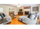 Cozy living room featuring hardwood floors, brick fireplace, and comfortable seating area at 2730 Tiffany Dr, Rock Hill, SC 29732
