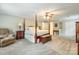 Large main bedroom with a four-poster bed, sitting area, and an en-suite bathroom at 2730 Tiffany Dr, Rock Hill, SC 29732