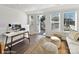 Bright living space featuring a desk, wooden floors, large windows and access to outdoor porch with egg chair at 3009 Loso Ter # 58, Charlotte, NC 28217