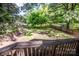 Fenced backyard featuring a grassy area, mature trees, and lawn furniture at 310 Patterson Ave, Mooresville, NC 28115