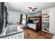Bedroom with wood floors, a ceiling fan, a bunk bed, and a crib at 310 Patterson Ave, Mooresville, NC 28115