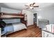 Bedroom with wood floors, a ceiling fan, a bunk bed, and a crib at 310 Patterson Ave, Mooresville, NC 28115
