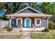 Charming bungalow with a bright blue front door, inviting porch, and meticulous landscaping at 310 Patterson Ave, Mooresville, NC 28115