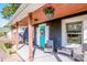 Inviting front porch seating area with a bright blue door, hanging flower baskets, and a cozy outdoor vibe at 310 Patterson Ave, Mooresville, NC 28115