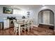 Modern kitchen featuring stainless appliances, granite countertops, white cabinets, and a dining area at 310 Patterson Ave, Mooresville, NC 28115