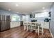 Spacious kitchen with white cabinets, stainless steel appliances, and a dining area perfect for Gathering meals at 310 Patterson Ave, Mooresville, NC 28115