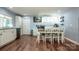 Open-concept kitchen featuring white cabinetry, granite countertops, stainless appliances, and a breakfast table at 310 Patterson Ave, Mooresville, NC 28115