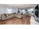 Open concept living room featuring hardwood floors and an attached kitchen with stainless appliances at 310 Patterson Ave, Mooresville, NC 28115