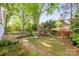 Landscaped backyard with brick walkway and a play set at 3101 Willowbrae Rd, Charlotte, NC 28226