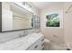 Well-lit bathroom featuring a marble vanity and subway tile in the shower at 3101 Willowbrae Rd, Charlotte, NC 28226