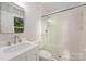 Bathroom featuring glass shower, mosaic floor, and modern fixtures at 3101 Willowbrae Rd, Charlotte, NC 28226
