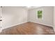 Bright bedroom with wood-look floors, neutral walls, and a window at 3101 Willowbrae Rd, Charlotte, NC 28226
