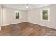 Comfortable bedroom with wood-look flooring and natural light from two windows at 3101 Willowbrae Rd, Charlotte, NC 28226