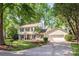 Charming two-story home with a well-manicured lawn and attached garage, surrounded by mature trees at 3101 Willowbrae Rd, Charlotte, NC 28226