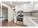 Bright kitchen featuring white cabinets, stone countertops, and stainless steel oven at 3101 Willowbrae Rd, Charlotte, NC 28226