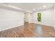 Spacious living room featuring hard surface floors, crown molding, and large windows at 3101 Willowbrae Rd, Charlotte, NC 28226