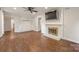 Cozy living room featuring a fireplace, built-in shelving, and wood-look floors at 3101 Willowbrae Rd, Charlotte, NC 28226